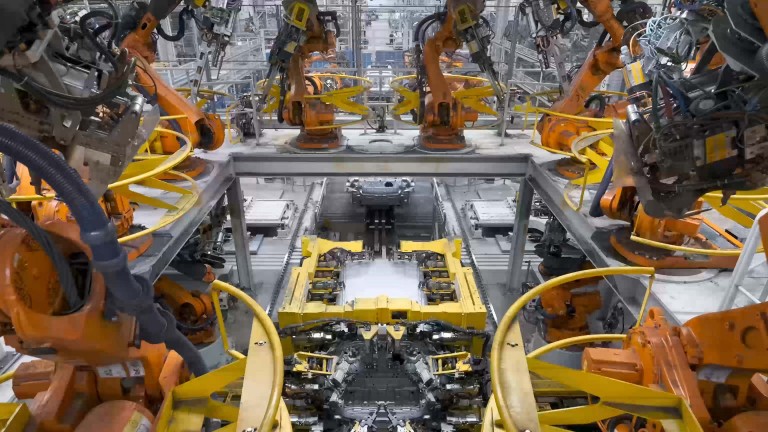 Eight robots work in unison in the main assembly building.